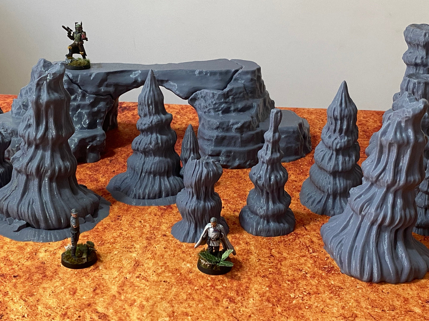 Figure depicting Boba Fett, Krennic and Shoretrooper standing on genosian desert rocks